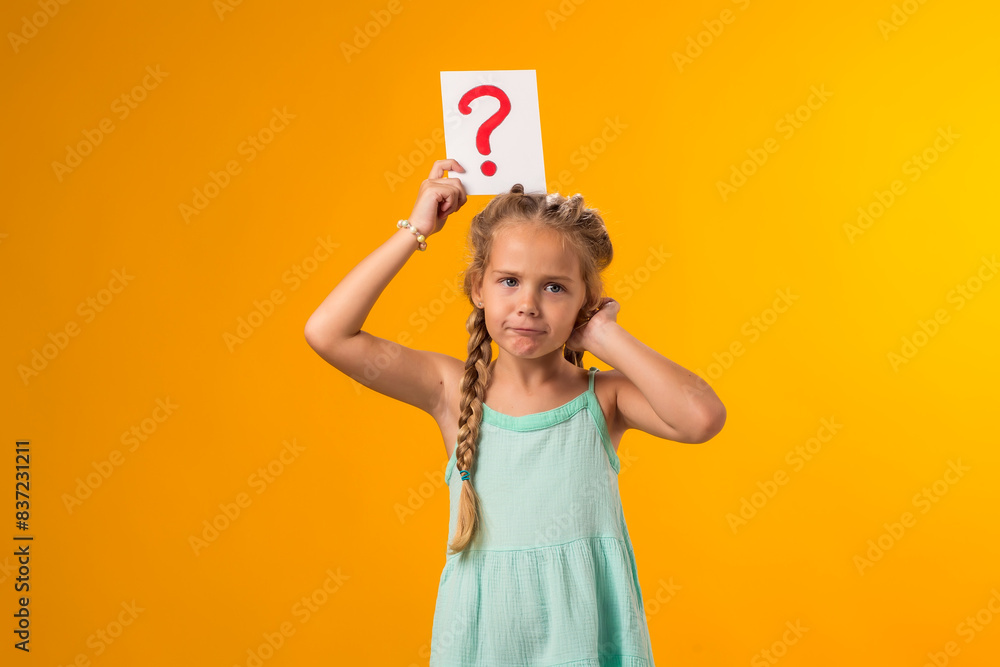 Thoughtful kid girl holding question mark card and scratching her head. Children, idea and knowledge concept Thoughtful kid girl holding question mark card and scratching her head. Children, idea and knowledge concept