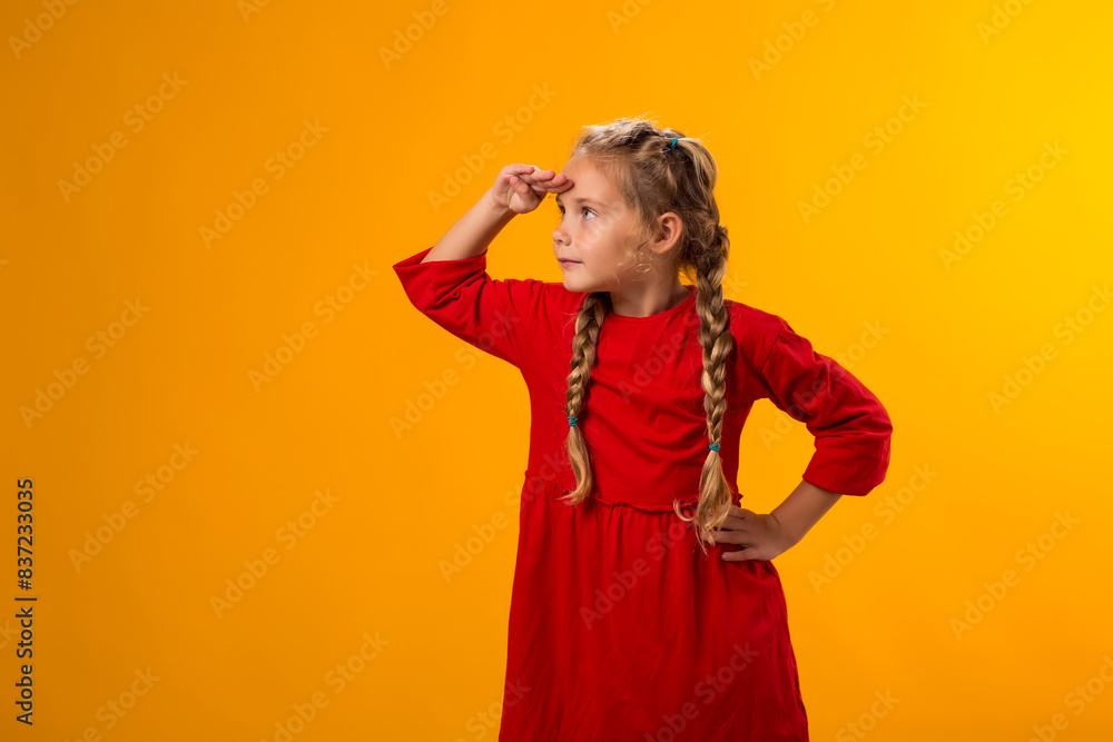Child girl holding hand over eyes and looking attentively far away. Curiosity and waiting concept Child girl holding hand over eyes and looking attentively far away. Curiosity and waiting concept