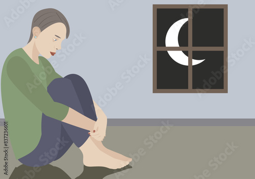Mujer deprimida en una habitación solitaria por la noche.
