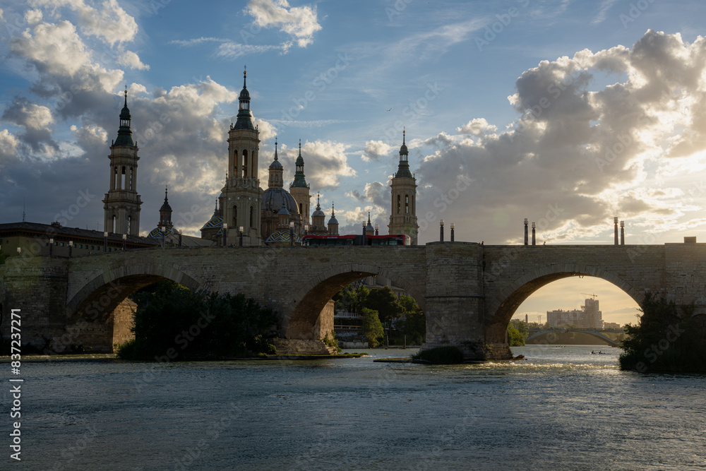 Naklejka premium Ebro river, Roman bridge and Pilar at sunset in Zaragoza, Aragon, Spain. 