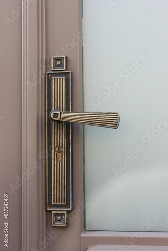 Metal door handle made in art deco style.