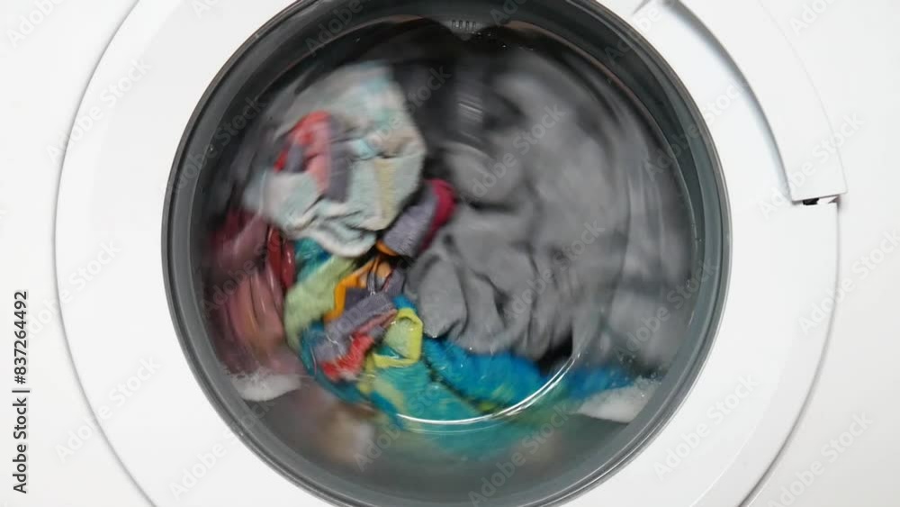 Many washable clothes in the drum of a home washing machine Many washable clothes in the drum of a home washing machine