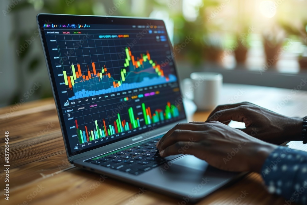Person Typing on Laptop With Chart Displayed Person Typing on Laptop With Chart Displayed