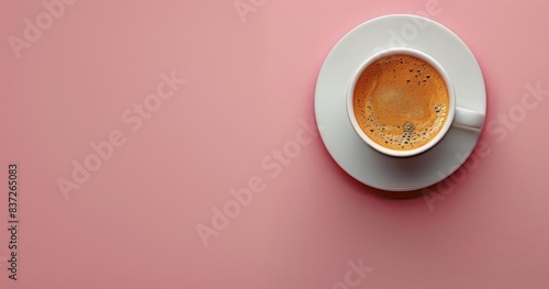 Overhead View of a Cup of Coffee With Foam on a Pink Background