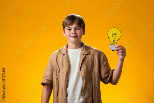 Wallpaper Mural Child boy holding paper bulb. Success, motivation, winner, genius, idea concept Torontodigital.ca