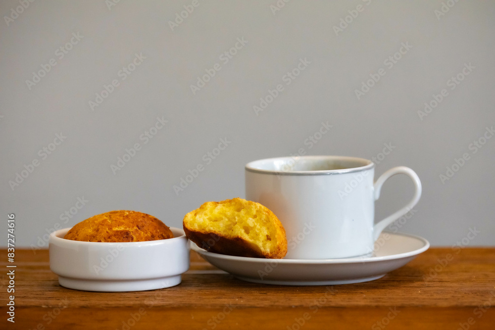 Afternoon coffee served in a white cup with cornbread or cheese bread Afternoon coffee served in a white cup with cornbread or cheese bread