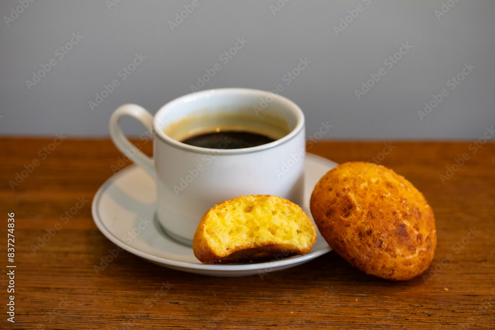 Afternoon coffee served in a white cup with cornbread or cheese bread Afternoon coffee served in a white cup with cornbread or cheese bread