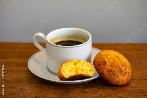 Afternoon coffee served in a white cup with cornbread or cheese bread