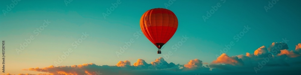 Naklejka premium Hot Air Balloon Serenity at Sunset - Vibrant Skies and Tranquil Freedom Above the Horizon