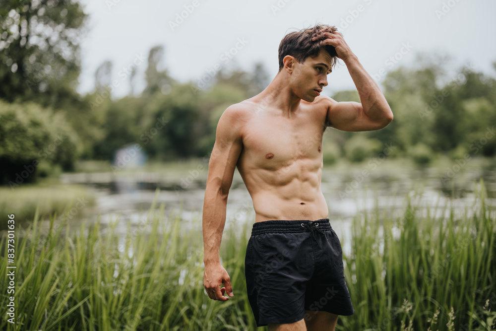 Fit young man posing shirtless outdoors in a natural setting with greenery. Fitness and healthy lifestyle concept. Fit young man posing shirtless outdoors in a natural setting with greenery. Fitness and healthy lifestyle concept.