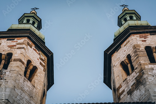 Two old small catholic church towers with crosses on green domes in Krakow, Poland photo