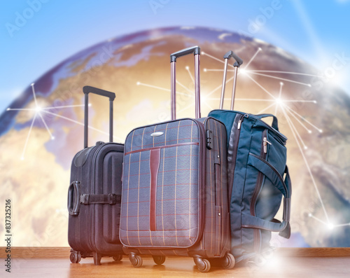Fototapeta Naklejka Na Ścianę i Meble -  International tourism. Travel suitcases. Planet earth blurred. Luggage for tourists. Suitcases on wheels for tourism. Traveler luggage. Global tourism. 3d image planet earth, elements from nasa