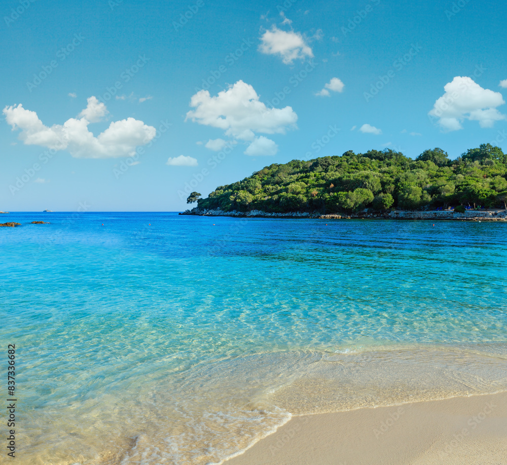 Fototapeta premium Beautiful Ionian Sea with clear turquoise water and morning summer coast view from beach (Ksamil, Albania).