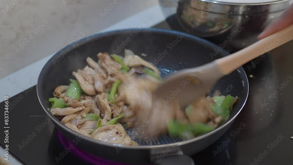 Cooking Chicken Stirfry with Vegetables in a Pan involves stirfrying ingredients on a stovetop Cooking Chicken Stirfry with Vegetables in a Pan involves stirfrying ingredients on a stovetop