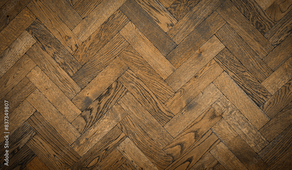Herringbone wood tile pattern on a floor or wall with antique finish