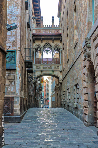 View of bridge between buildings in Barri Gotic quarter of Barcelona, Spain. photo