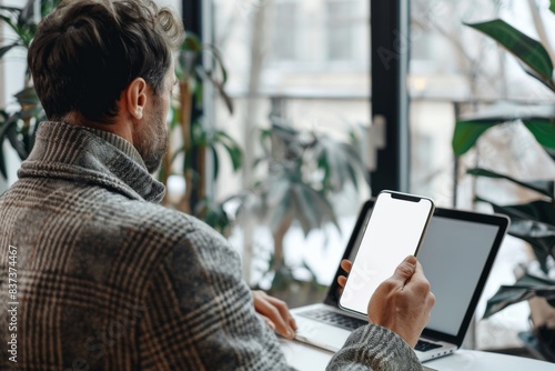 Person sitting table laptop plant