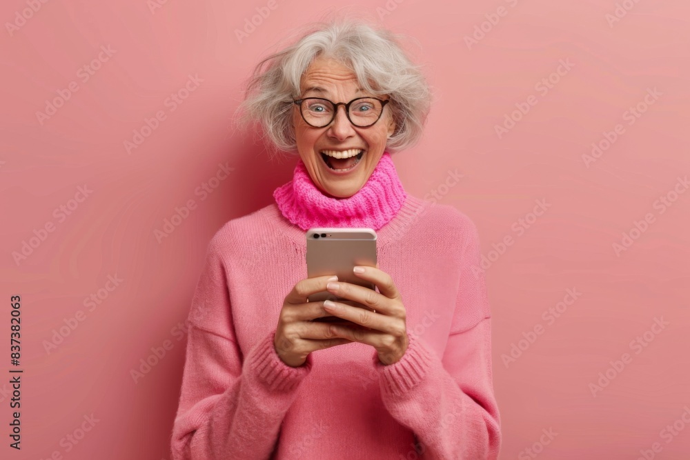 Woman pink sweater phone focus smile Woman pink sweater phone focus smile