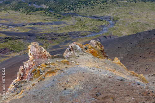 Osorno volcano mountain summit in Chile, Patagonia Andes. The ring of fire volcanic landscape with crater and lava active volcano in South America. Red rock frozen lava and snow on volcano top photo