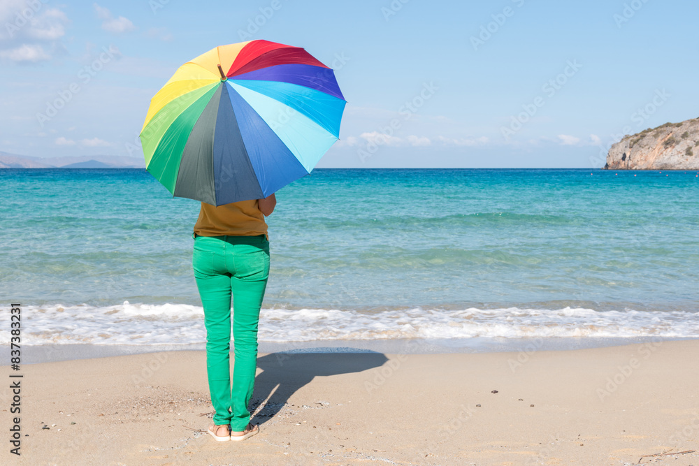 Young woman with colorful umbrella on the beach. Summer concept. Young woman with colorful umbrella on the beach. Summer concept.