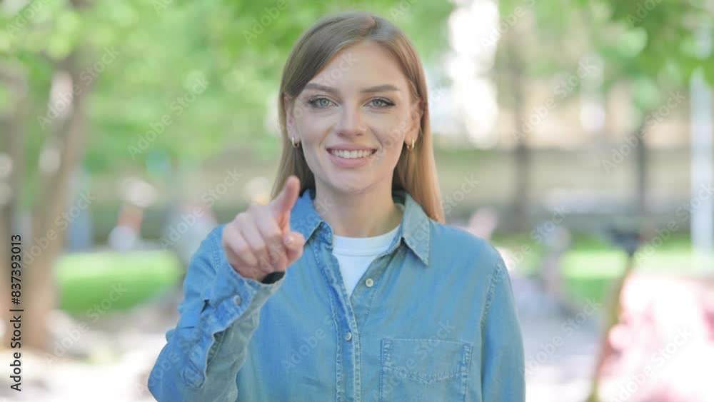 Young Woman Pointing at Camera Outdoor in Park Young Woman Pointing at Camera Outdoor in Park