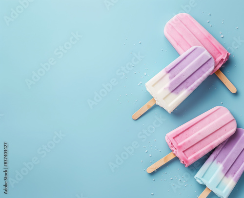 Colorful ice cream popsicles on blue copy space