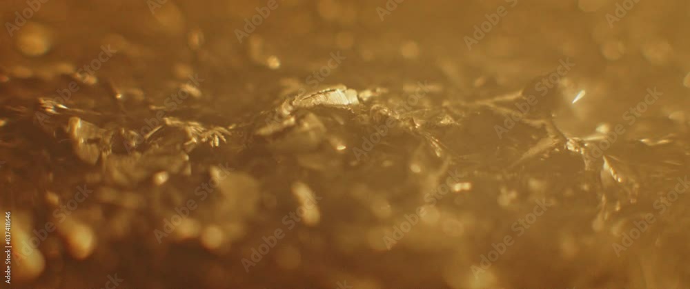 Gold alloy metallic pieces moving Gold alloy metallic pieces moving
