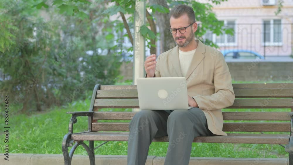 Young Man Shocked by Loss on Laptop while Sitting Outdoor Young Man Shocked by Loss on Laptop while Sitting Outdoor