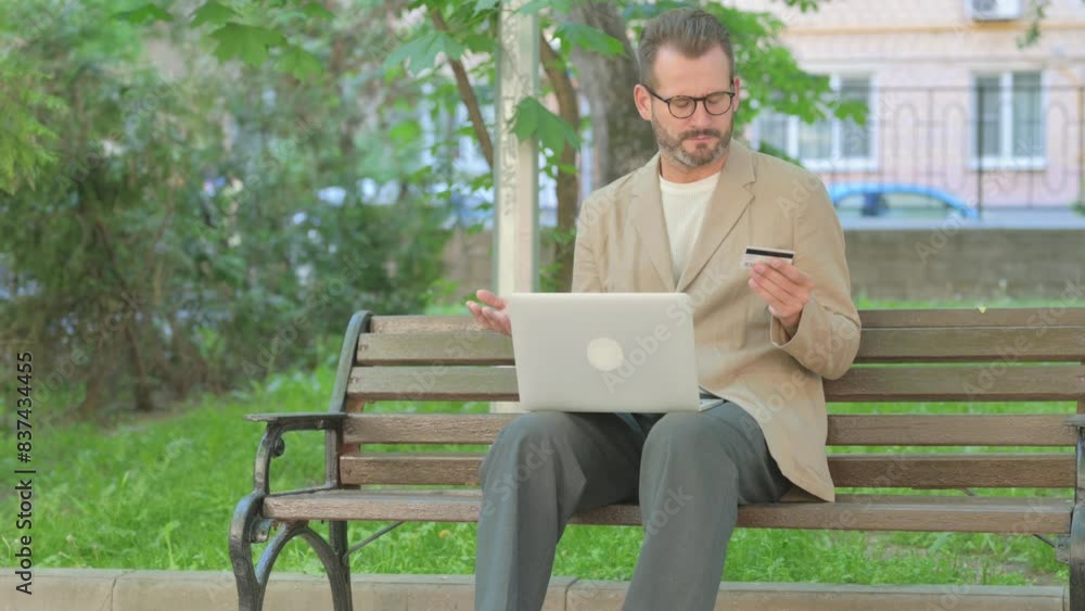 Young Man having Online Banking Failure while Sitting Outdoor Young Man having Online Banking Failure while Sitting Outdoor