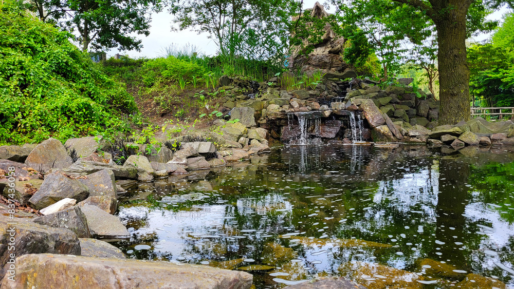 The artificial pond is lined with stones The artificial pond is lined with stones