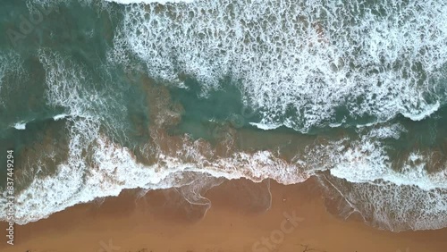 waves crashing on the shoreline of tropical island paradise vacation travel tourism destination (luquillo, puerto rico) sand wave beach shore (sunset, dusk, night time, getaway) aerial drone footage photo