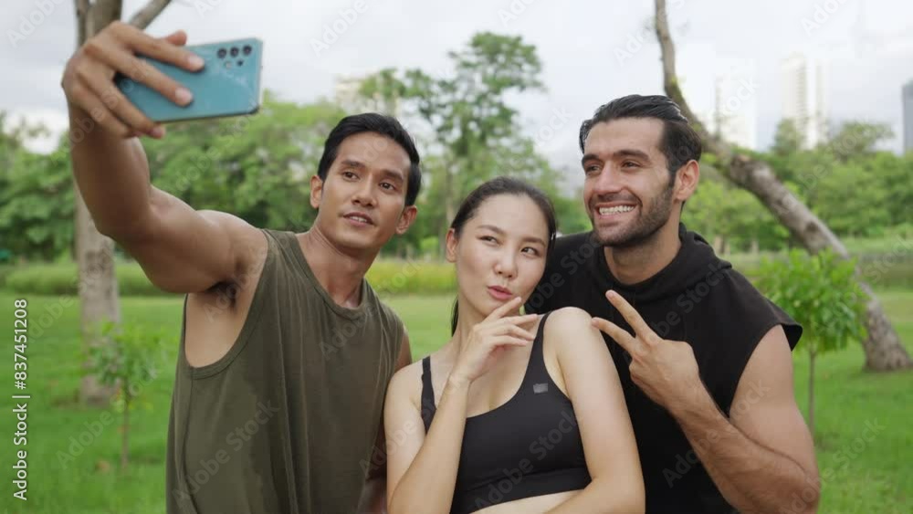 Group of Happy Man and woman friends using mobile phone taking selfie together during jogging exercise together at public park. Healthy people enjoy outdoor sport training running workout in the city. Group of Happy Man and woman friends using mobile phone taking selfie together during jogging exercise together at public park. Healthy people enjoy outdoor sport training running workout in the city.
