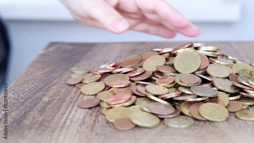 female hand counts cash money European Union, manipulate with metal coins, puts euro union money on table, concept budget control, social assistance to poor, life insurance female hand counts cash money European Union, manipulate with metal coins, puts euro union money on table, concept budget control, social assistance to poor, life insurance