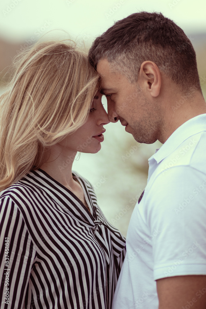 Couple standing forehead to forehead by the river. Couple standing forehead to forehead by the river.