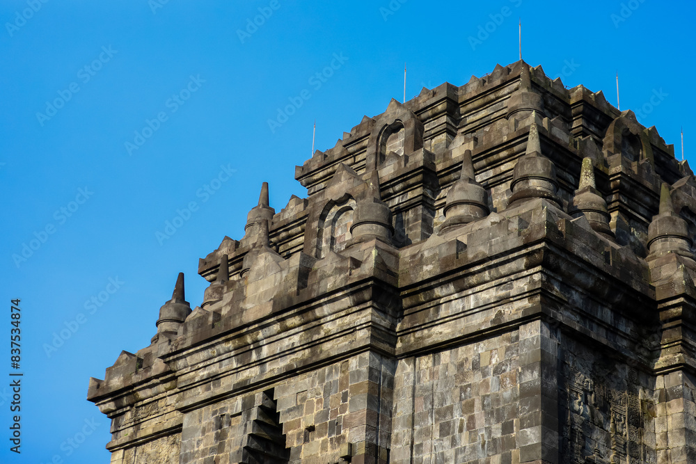 Ancient Temple Architecture with Detailed Stone Carvings and Majestic Spires against a Clear Blue Sky ; candi prambanan indonesia tourism Ancient Temple Architecture with Detailed Stone Carvings and Majestic Spires against a Clear Blue Sky ; candi prambanan indonesia tourism