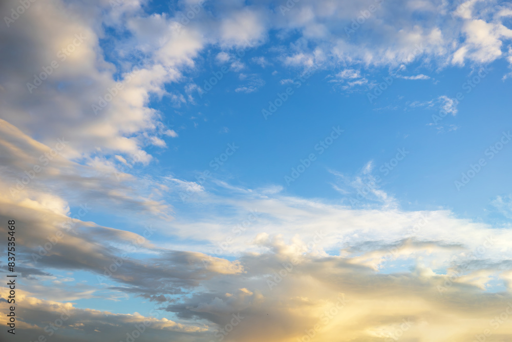 Majestic dusk. Beautiful bright blue sky with vivid golden clouds. Soft cloud in twilight. Calm cloudy sky on evening time. Abstract nature background. Fresh air, weather and freedom concept Majestic dusk. Beautiful bright blue sky with vivid golden clouds. Soft cloud in twilight. Calm cloudy sky on evening time. Abstract nature background. Fresh air, weather and freedom concept