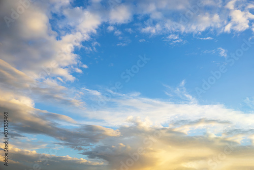 Majestic dusk. Beautiful bright blue sky with vivid golden clouds. Soft cloud in twilight. Calm cloudy sky on evening time. Abstract nature background. Fresh air  weather and freedom concept