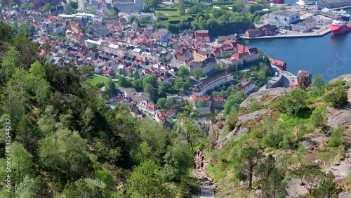 Drone shot from the top of famous Stoltzekleiven. People arriving at the summit and some walking down again. Beautiful views of Bergen and Sandviken below. photo