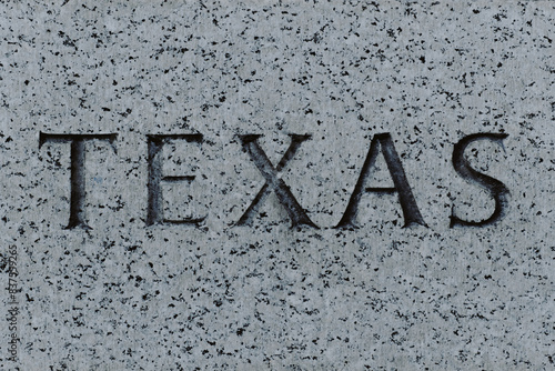 The words Texas engraved in granite stone