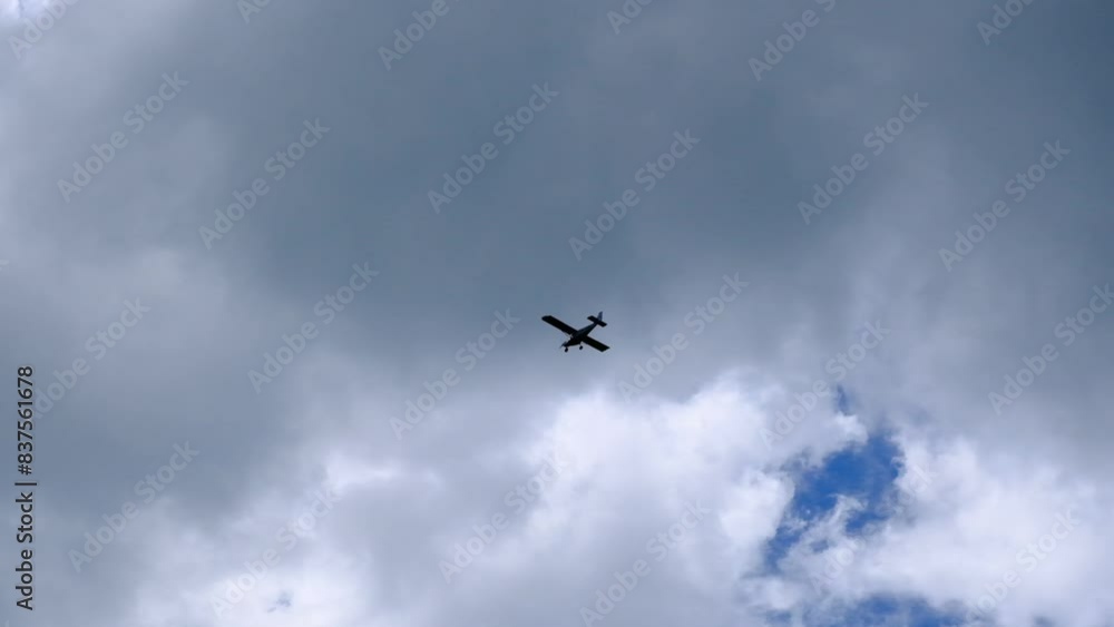 a small propeller plane in the cloudy sky, from far away a small propeller plane in the cloudy sky, from far away