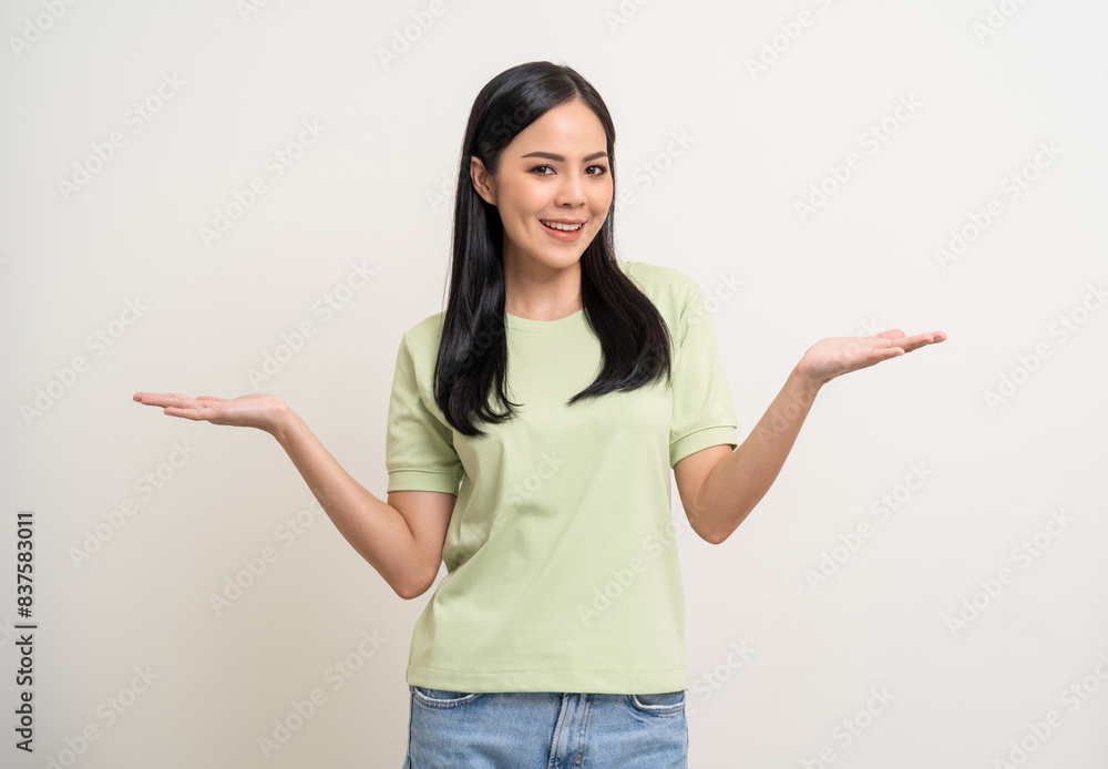 Beautiful smiling happy young asian woman in green shirt. Charming female lady open hands palm up holding something on isolated white background. Asian woman cute Pretty people looking blank space. Beautiful smiling happy young asian woman in green shirt. Charming female lady open hands palm up holding something on isolated white background. Asian woman cute Pretty people looking blank space.