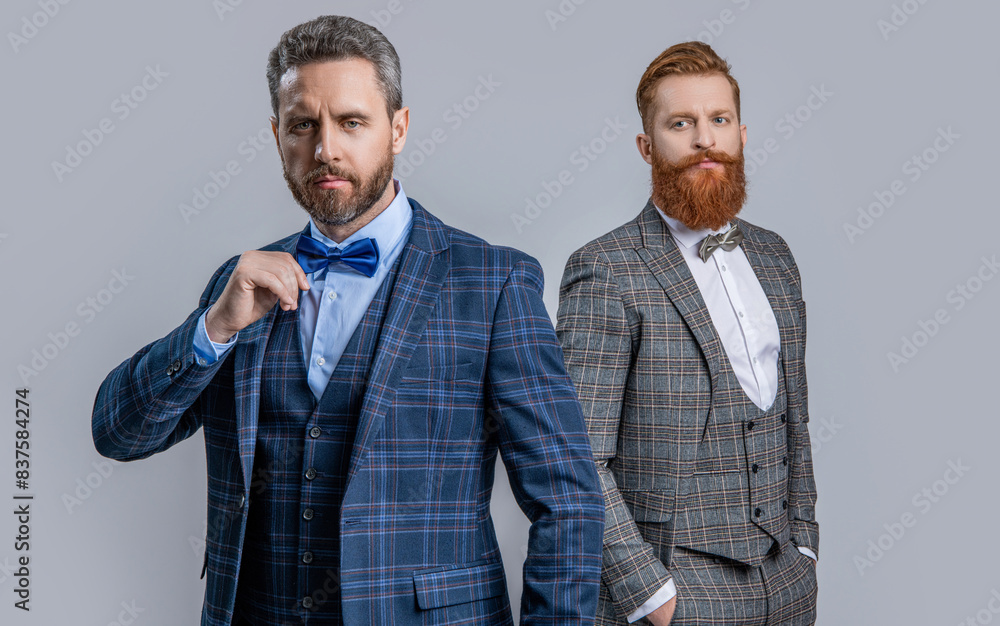 Tuxedo men in formalwear isolated on grey. Tuxedo men in formalwear. Tuxedo men wear formalwear fashion. Elegant men in menswear with bowtie. Two businessmen at business event. Formal menswear Tuxedo men in formalwear isolated on grey. Tuxedo men in formalwear. Tuxedo men wear formalwear fashion. Elegant men in menswear with bowtie. Two businessmen at business event. Formal menswear