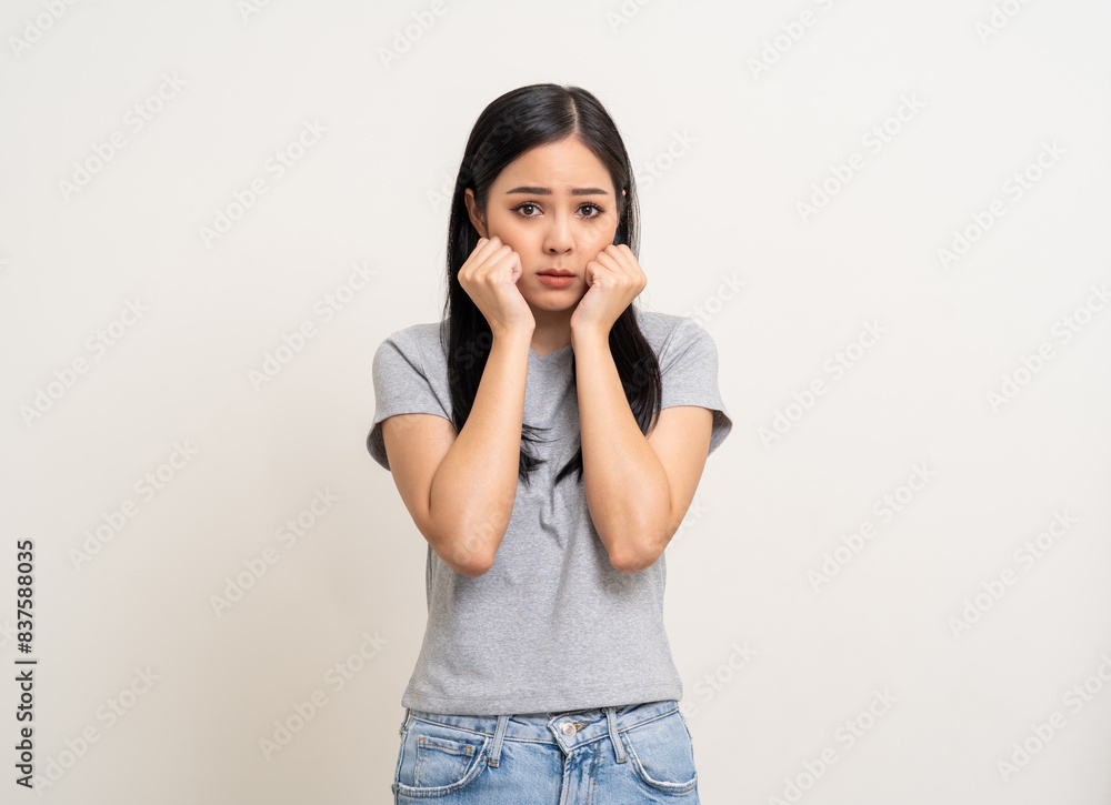Upset confused bad emotional and thinking asian woman. Unhappy stressed female. Young latin lady standing feeling depressed dramatic scene looking at camera on isolated background. Upset confused bad emotional and thinking asian woman. Unhappy stressed female. Young latin lady standing feeling depressed dramatic scene looking at camera on isolated background.