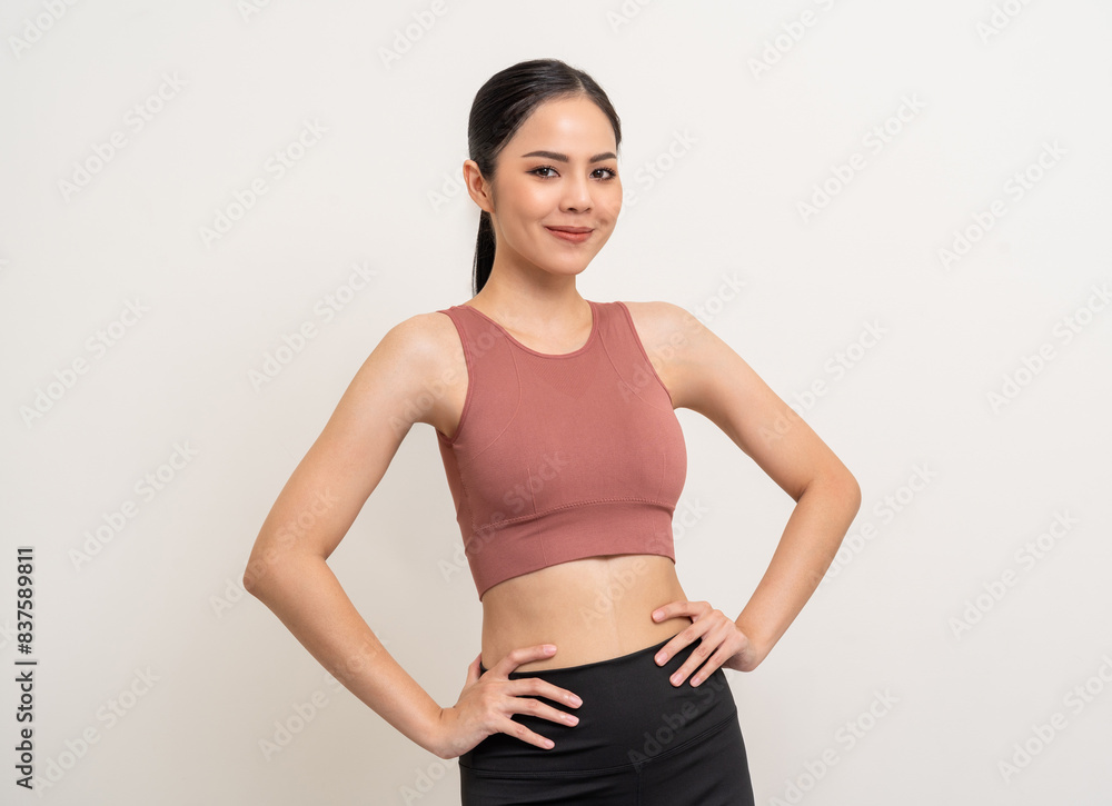 Young beautiful smiling asian woman with sportswear on isolated white background. Portrait happy healthy slim fit and firm latin attractive sporty woman standing pose exercise workout in studio. Young beautiful smiling asian woman with sportswear on isolated white background. Portrait happy healthy slim fit and firm latin attractive sporty woman standing pose exercise workout in studio.