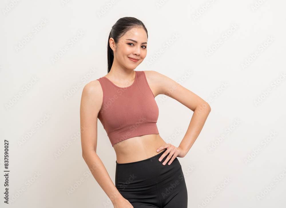 Young beautiful smiling asian woman with sportswear on isolated white background. Portrait happy healthy slim fit and firm latin attractive sporty woman standing pose exercise workout in studio. Young beautiful smiling asian woman with sportswear on isolated white background. Portrait happy healthy slim fit and firm latin attractive sporty woman standing pose exercise workout in studio.