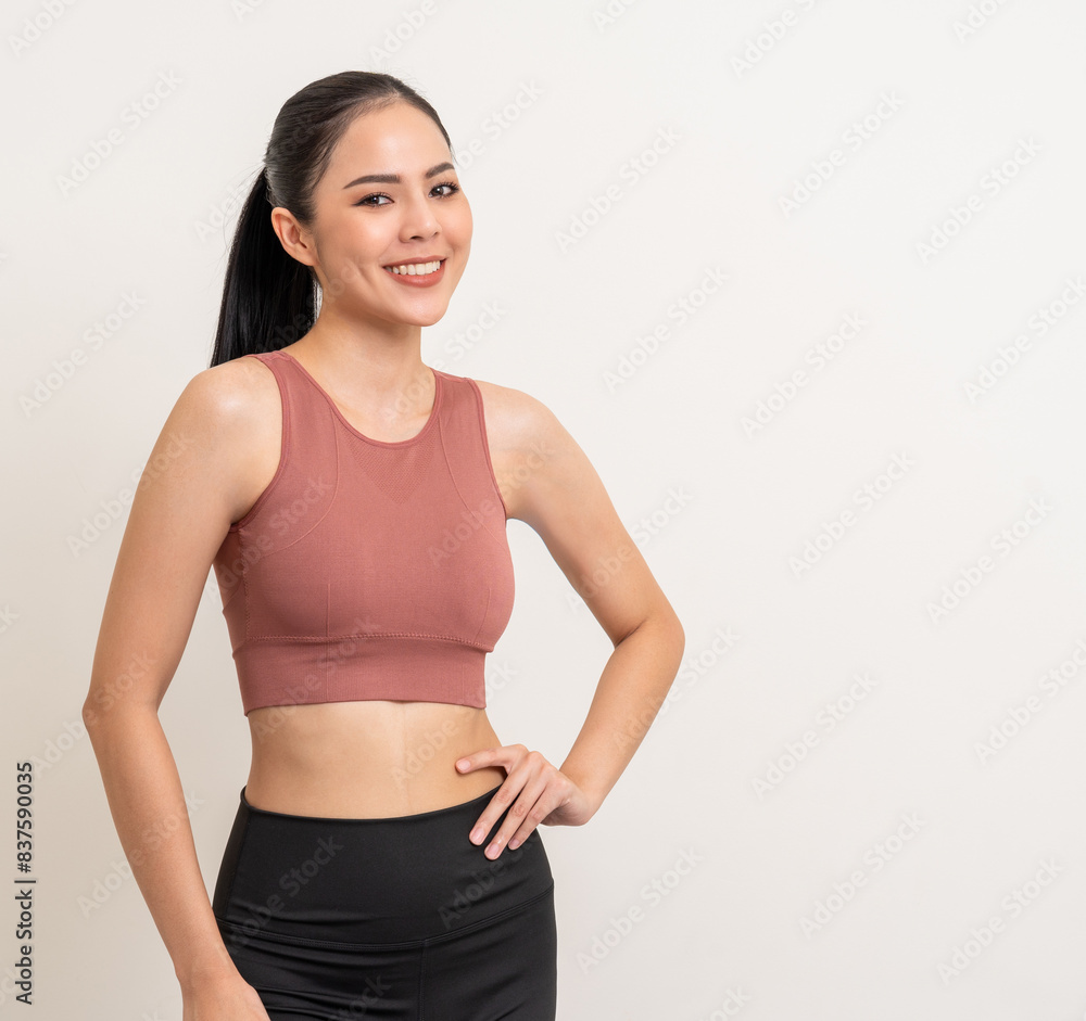 Young beautiful smiling asian woman with sportswear on isolated white background. Portrait happy healthy slim fit and firm latin attractive sporty woman standing pose exercise workout in studio. Young beautiful smiling asian woman with sportswear on isolated white background. Portrait happy healthy slim fit and firm latin attractive sporty woman standing pose exercise workout in studio.