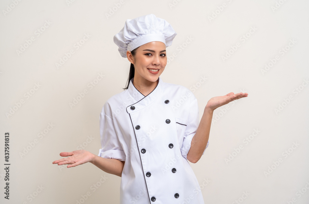 Smiling Young beautiful asian woman chef in uniform casual posing palm up hand on copy space isolated background. Cooking woman Occupation chef or baker People in kitchen restaurant and hotel. Smiling Young beautiful asian woman chef in uniform casual posing palm up hand on copy space isolated background. Cooking woman Occupation chef or baker People in kitchen restaurant and hotel.