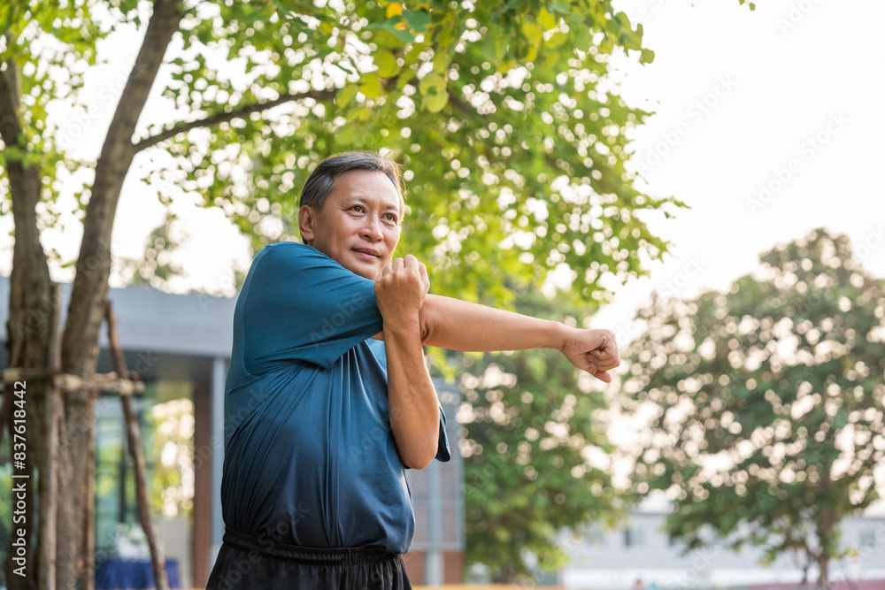 Senior old asian man wearing sportswear warming up before running outdoor. Portraits of Mature man stretching body before running at public park. Training athlete work out at outdoor nature Senior old asian man wearing sportswear warming up before running outdoor. Portraits of Mature man stretching body before running at public park. Training athlete work out at outdoor nature