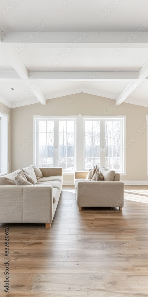 Fototapeta premium Minimalist living room interiors in neutral tones and natural lighting.