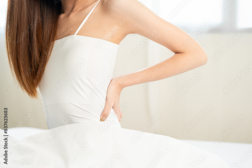 Waking up with a headache has problem pain with structural posture She had backache. Beautiful woman can't sleep moving restless on bed. Young woman having bad dream Waking up with a headache has problem pain with structural posture She had backache. Beautiful woman can't sleep moving restless on bed. Young woman having bad dream